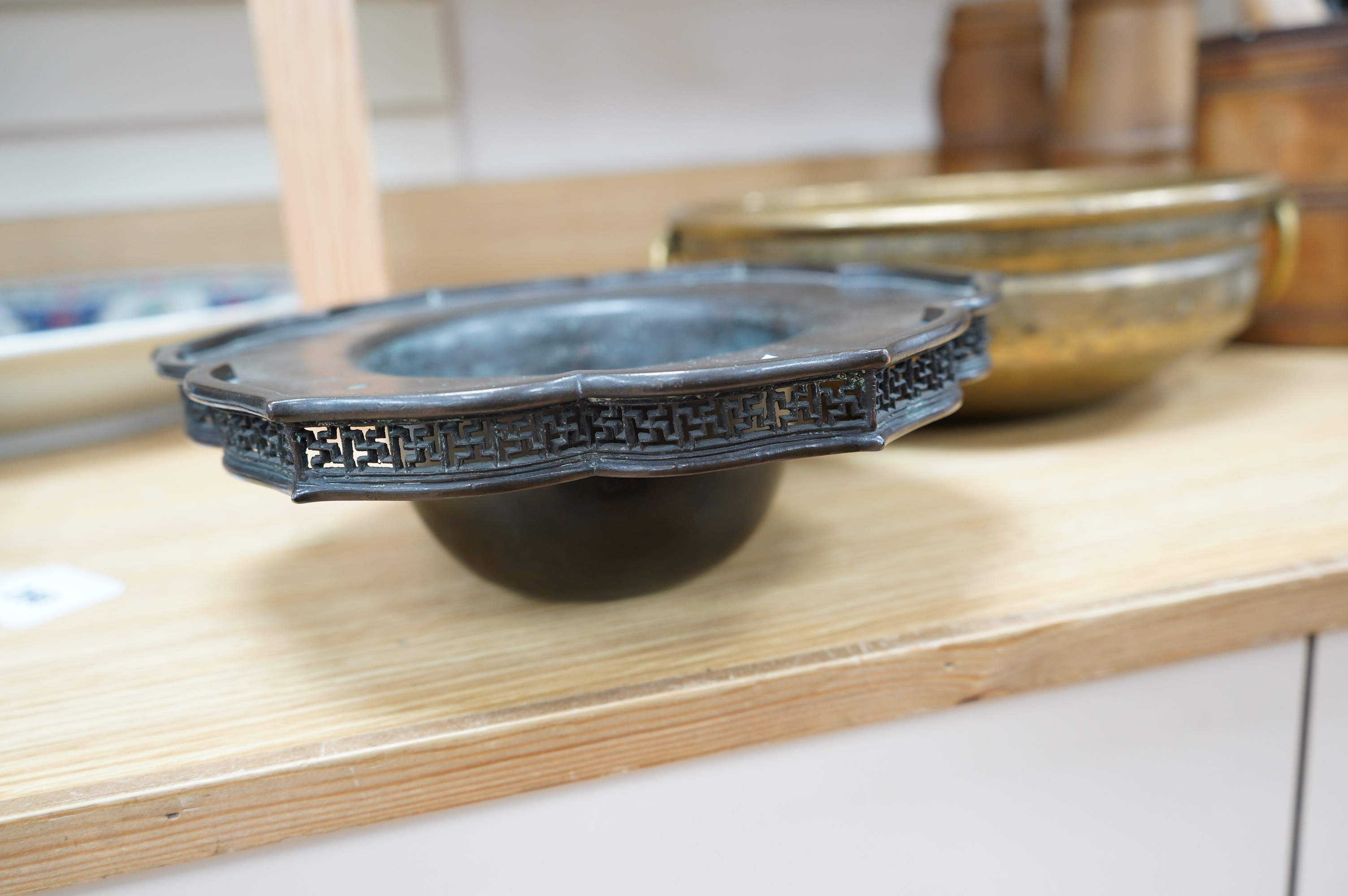 A Chinese bronze lotus dish with reticulated border, 27cm diameter, and a bronze two handled bowl, 29cm diameter. Condition - fair